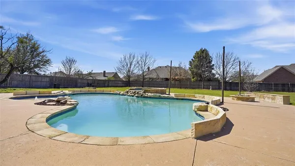 a view of swimming pool with outdoor seating and yard in back