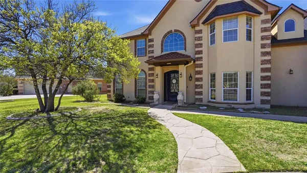 a front view of a house with a yard
