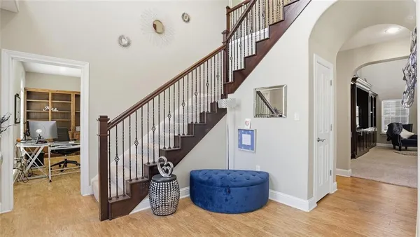 a view of entryway and hall with wooden floor