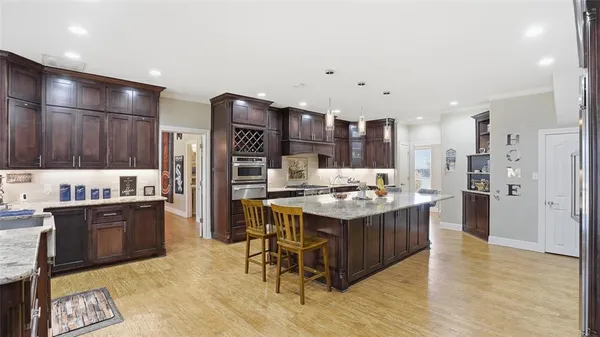 a kitchen with stainless steel appliances granite countertop a stove and a refrigerator