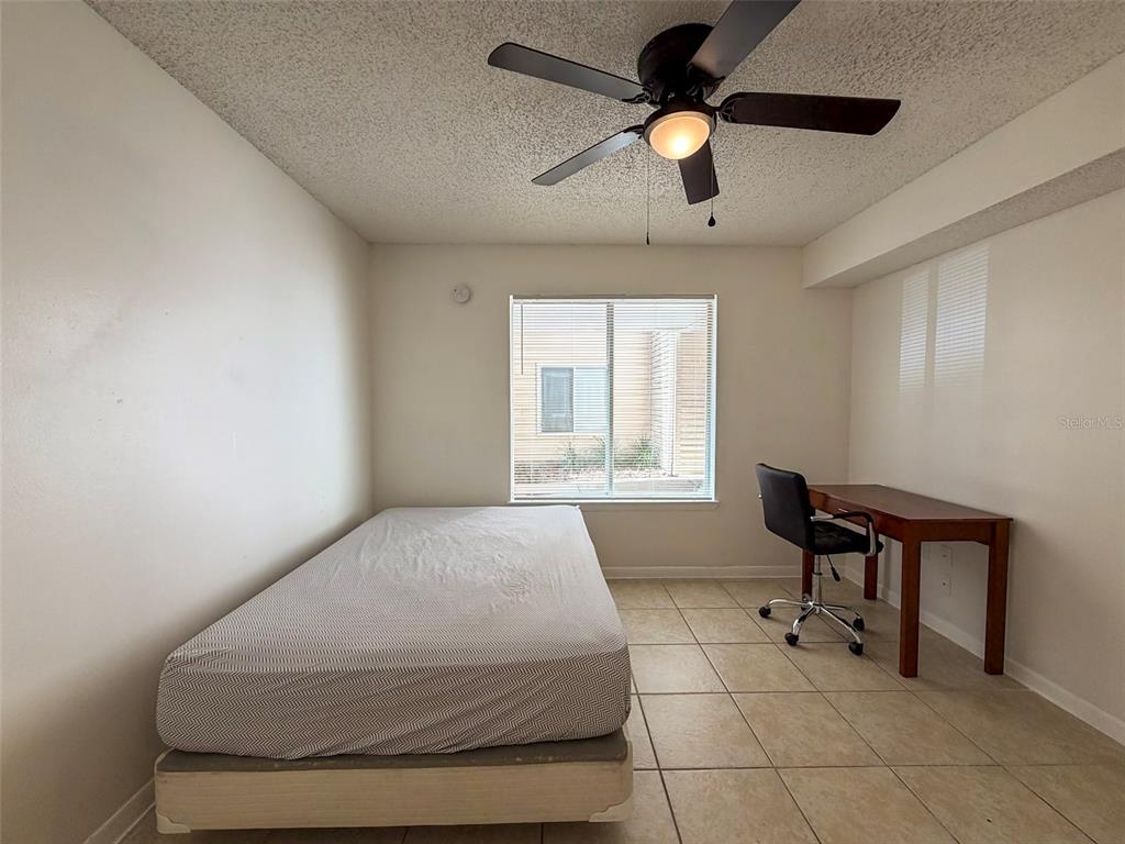 3921 Southwest 34th Street, Unit 301 Gainesville, FL 32608 - Photo 15 of 31 a bedroom with a bed and a window