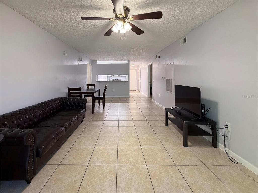 3921 Southwest 34th Street, Unit 301 Gainesville, FL 32608 - Photo 18 of 31 a living room with furniture and a flat screen tv