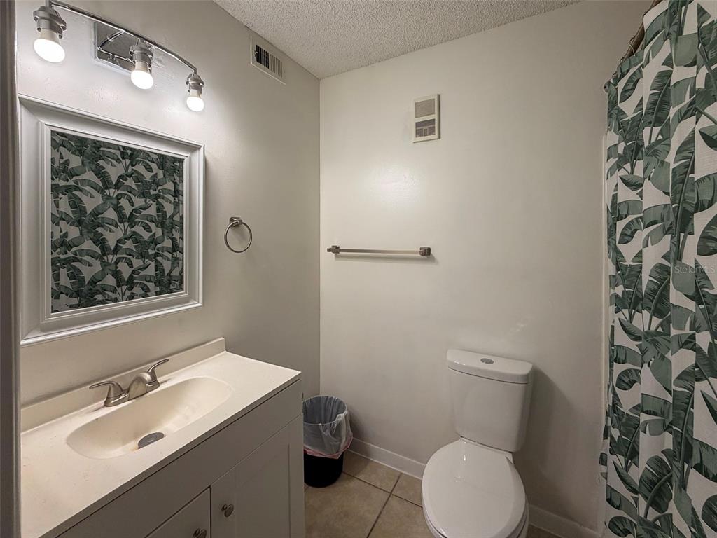 3921 Southwest 34th Street, Unit 301 Gainesville, FL 32608 - Photo 20 of 31 a bathroom with a toilet sink and mirror