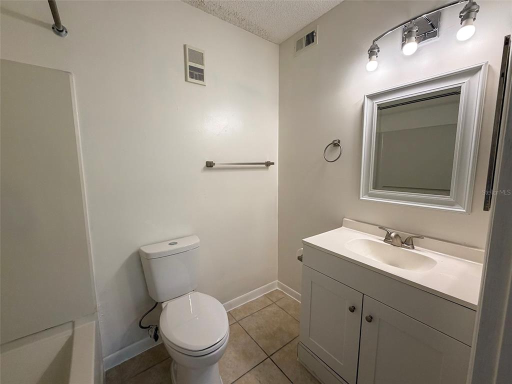3921 Southwest 34th Street, Unit 301 Gainesville, FL 32608 - Photo 24 of 31 a bathroom with a toilet sink and mirror