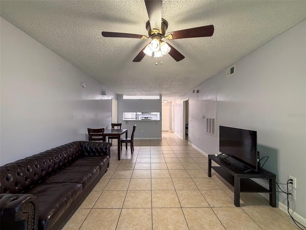 3921 Southwest 34th Street, Unit 301 Gainesville, FL 32608 - Photo 27 of 31 a living room with furniture and a flat screen tv