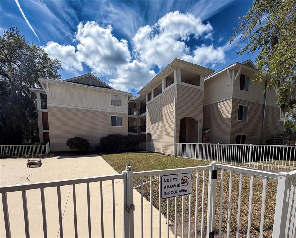 3921 Southwest 34th Street, Unit 301 Gainesville, FL 32608 - Photo 31 of 31 a view of a brick house with wooden fence
