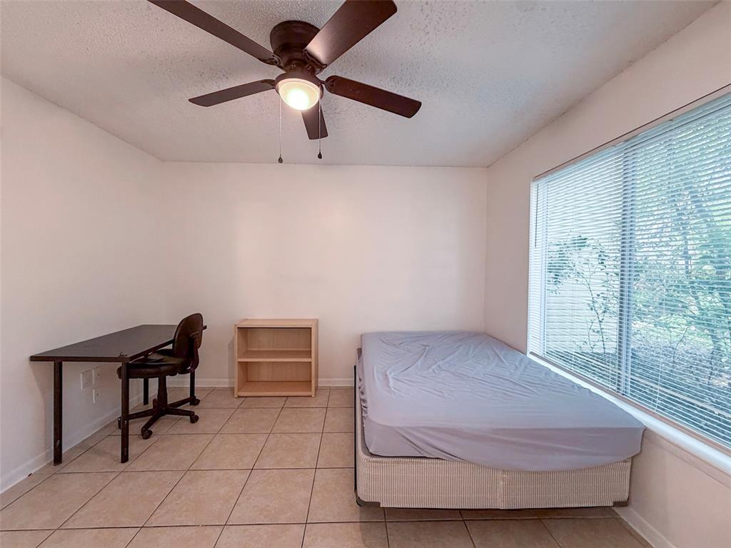 3921 Southwest 34th Street, Unit 301 Gainesville, FL 32608 - Photo 9 of 31 a bedroom with a bed and a window