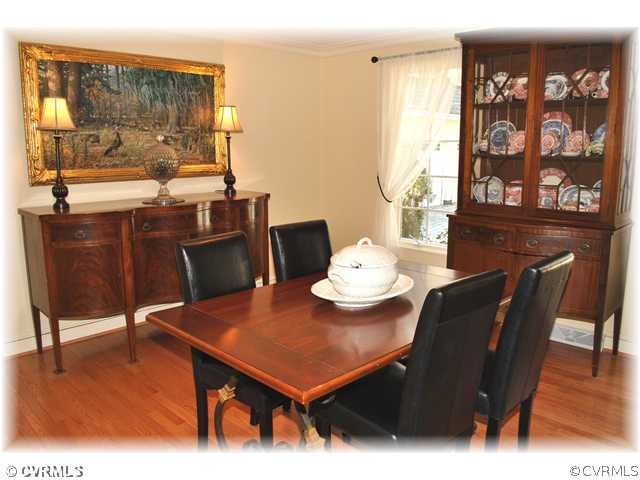 2821 West Brigstock Road Midlothian, VA 23113 - Photo 3 of 12 a view of a dining room with furniture and wooden floor