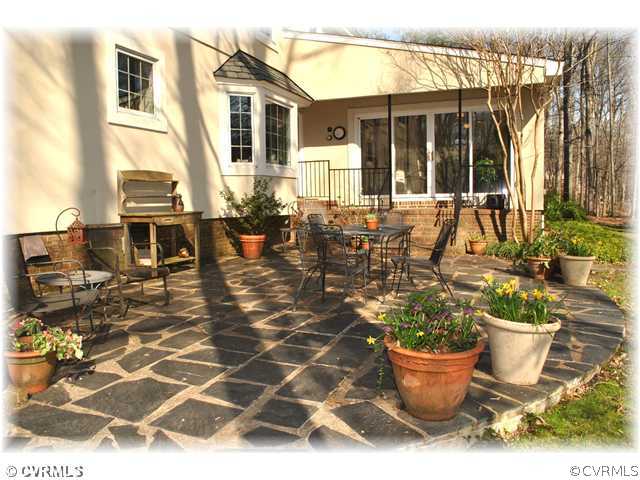 2821 West Brigstock Road Midlothian, VA 23113 - Photo 10 of 12 a view of a patio with table and chairs potted plants