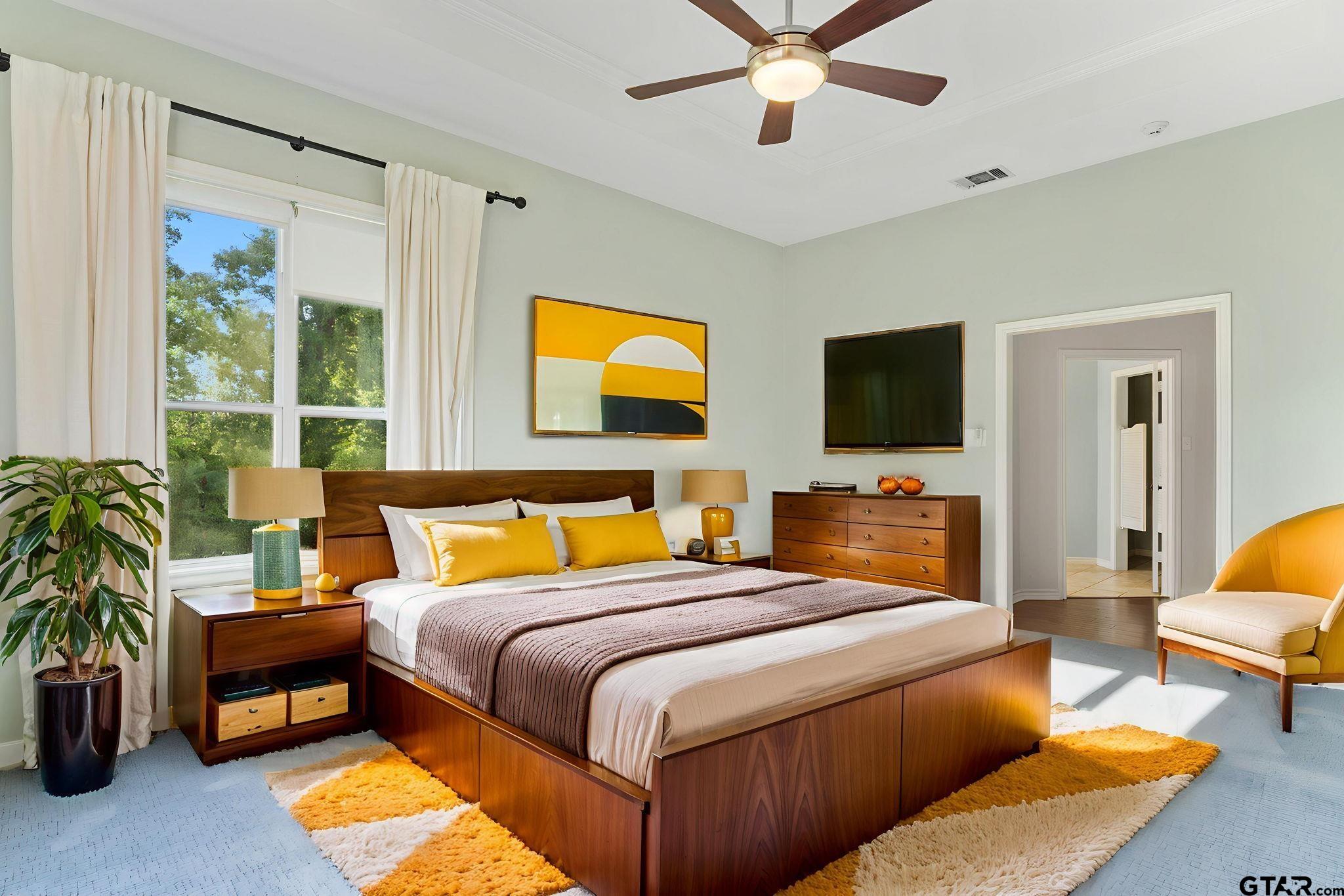 7031 Ridge Pl Circle Tyler, TX 75703 - Photo 11 of 27 a bedroom with a bed and a flat screen tv