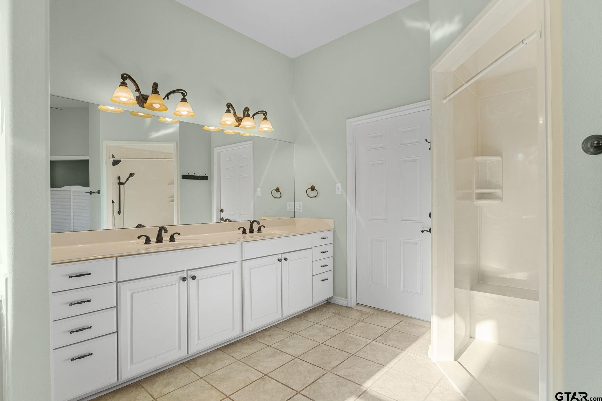 7031 Ridge Pl Circle Tyler, TX 75703 - Photo 12 of 27 a spacious bathroom with a double vanity sink mirror and