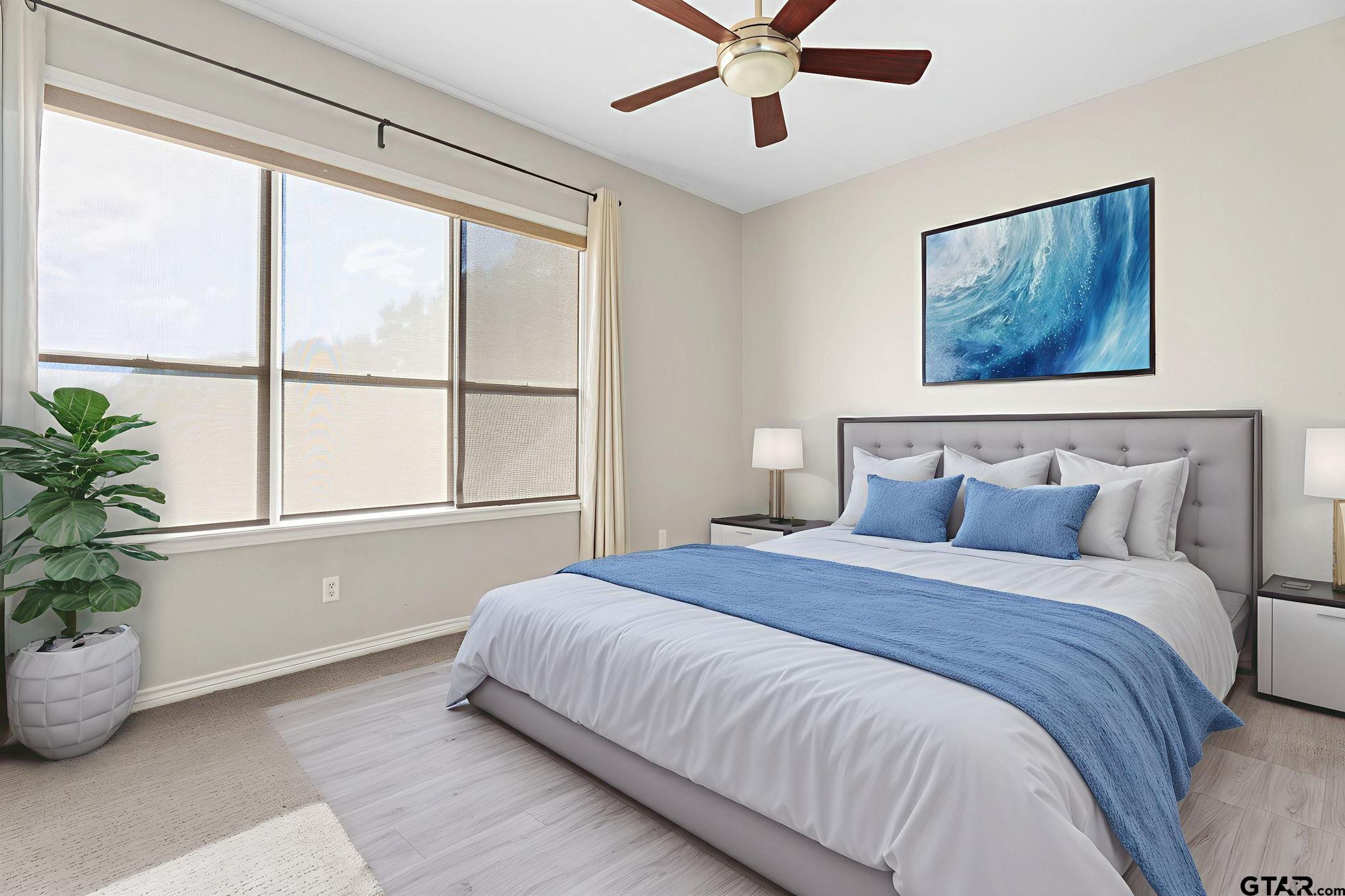 7031 Ridge Pl Circle Tyler, TX 75703 - Photo 16 of 27 a bedroom with a large bed and a potted plant