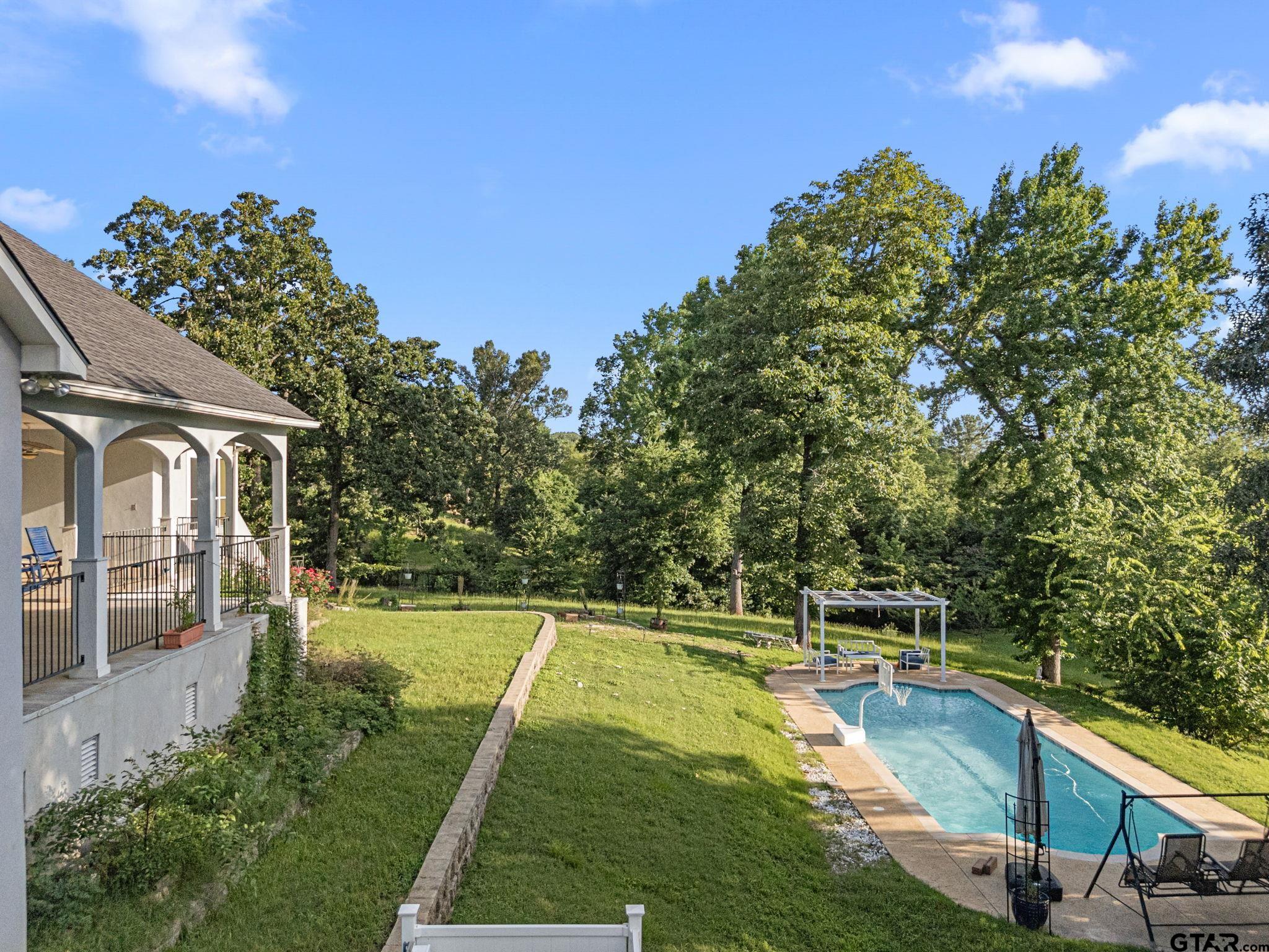 7031 Ridge Pl Circle Tyler, TX 75703 - Photo 20 of 27 a view of a house with swimming pool