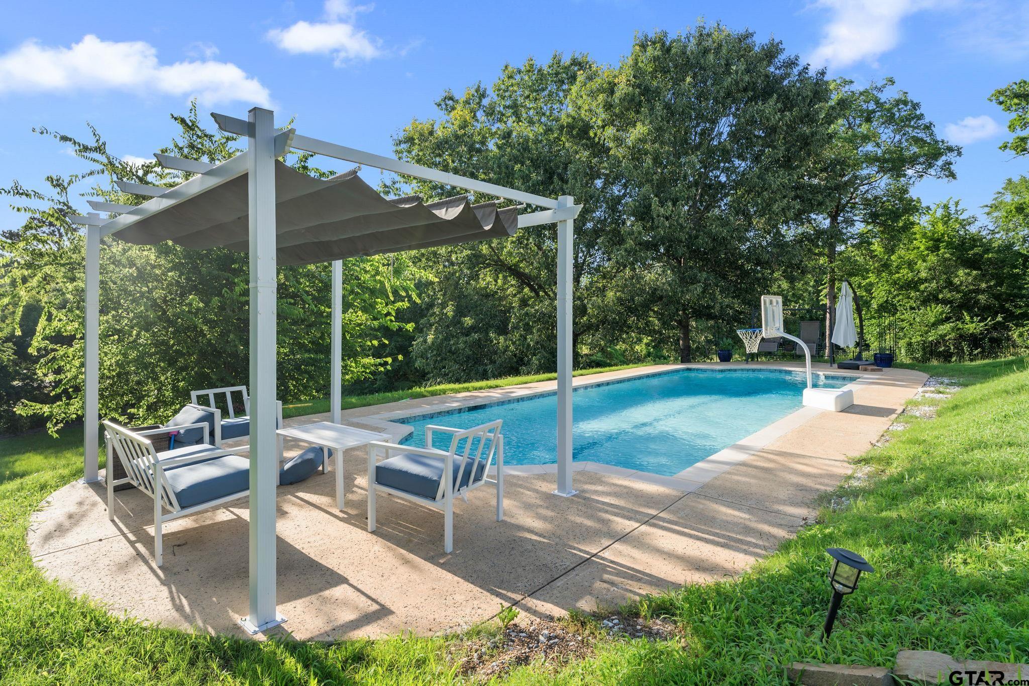 7031 Ridge Pl Circle Tyler, TX 75703 - Photo 21 of 27 a view of a patio with a table chairs and a backyard