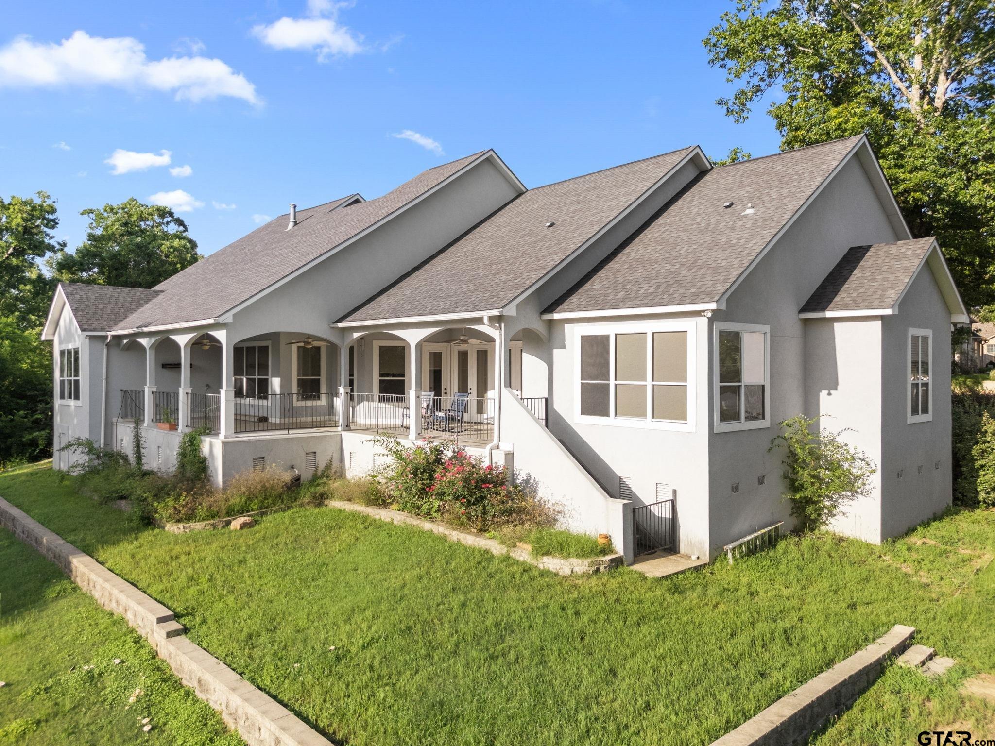 7031 Ridge Pl Circle Tyler, TX 75703 - Photo 24 of 27 a front view of a house with a yard
