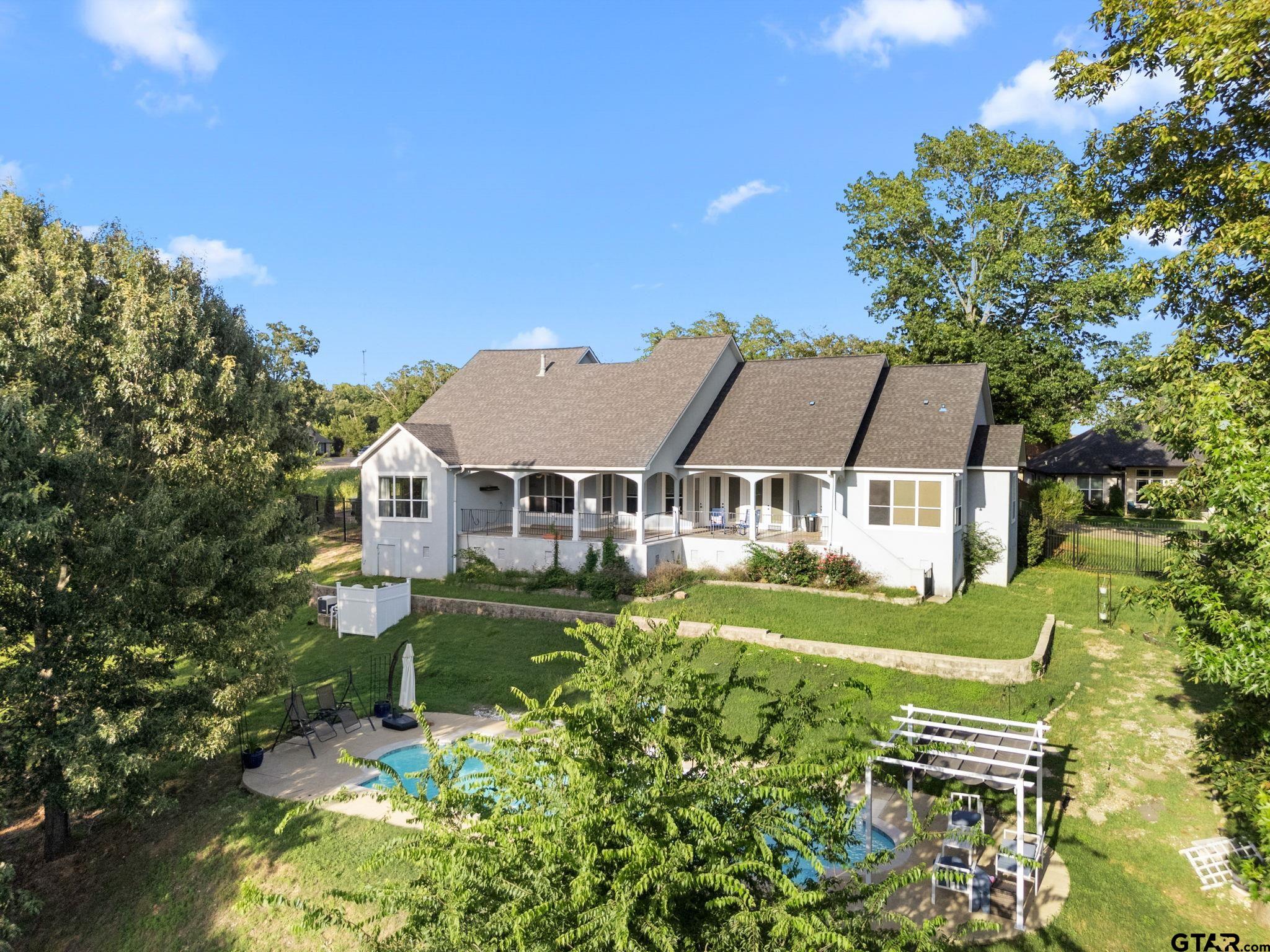 7031 Ridge Pl Circle Tyler, TX 75703 - Photo 25 of 27 a front view of a house with a garden