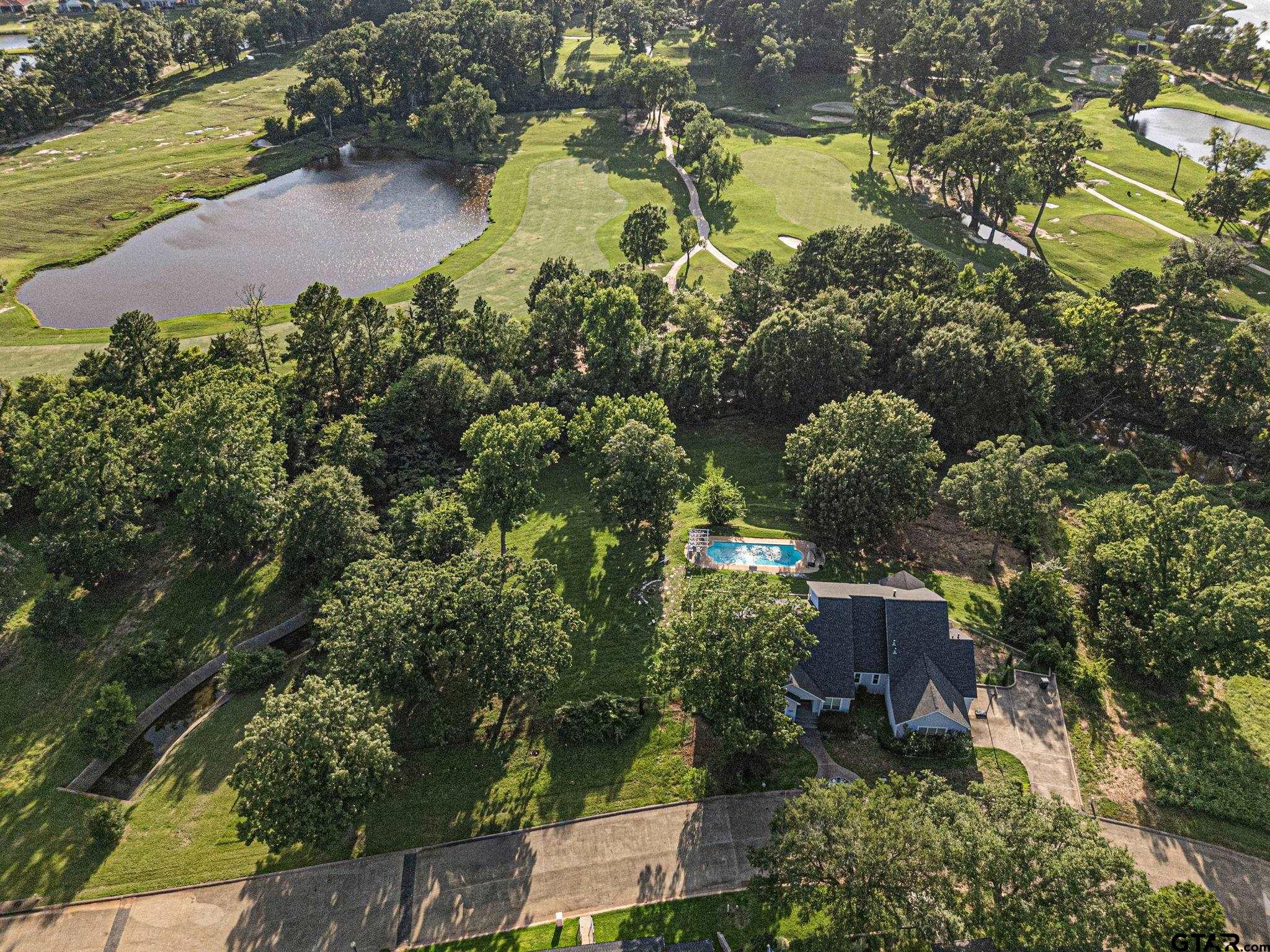 7031 Ridge Pl Circle Tyler, TX 75703 - Photo 26 of 27 an aerial view of a house with a lake view