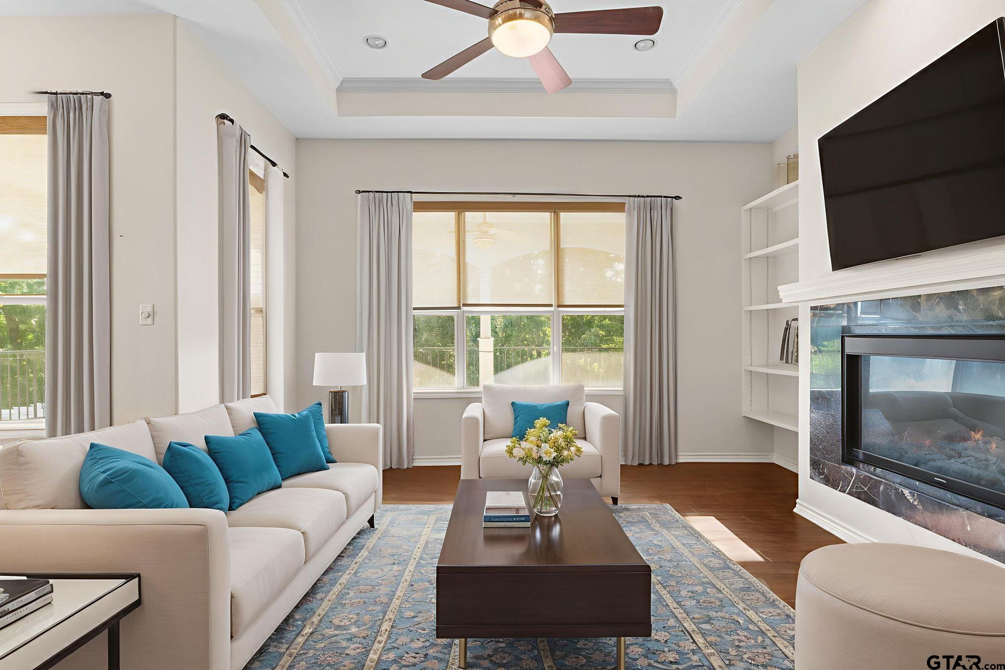 7031 Ridge Pl Circle Tyler, TX 75703 - Photo 9 of 27 a living room with furniture a fireplace and a flat screen tv