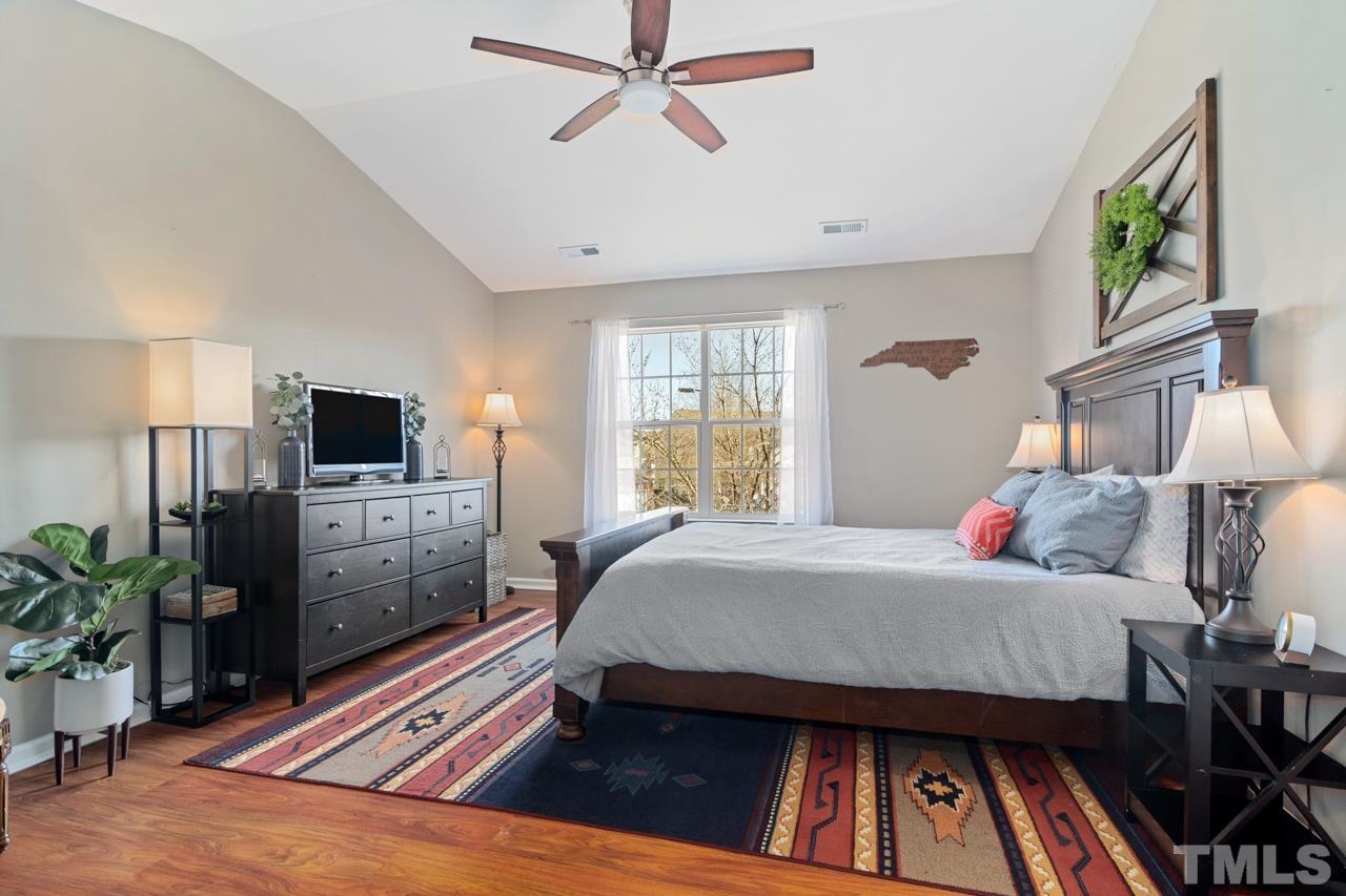 32 Brafferton Court Durham, NC 27713 - Photo 12 of 32 a bedroom with a bed and flat screen tv