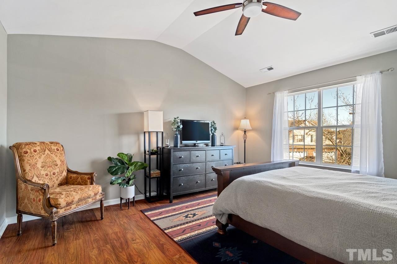 32 Brafferton Court Durham, NC 27713 - Photo 13 of 32 a spacious bedroom with a bed and a chair