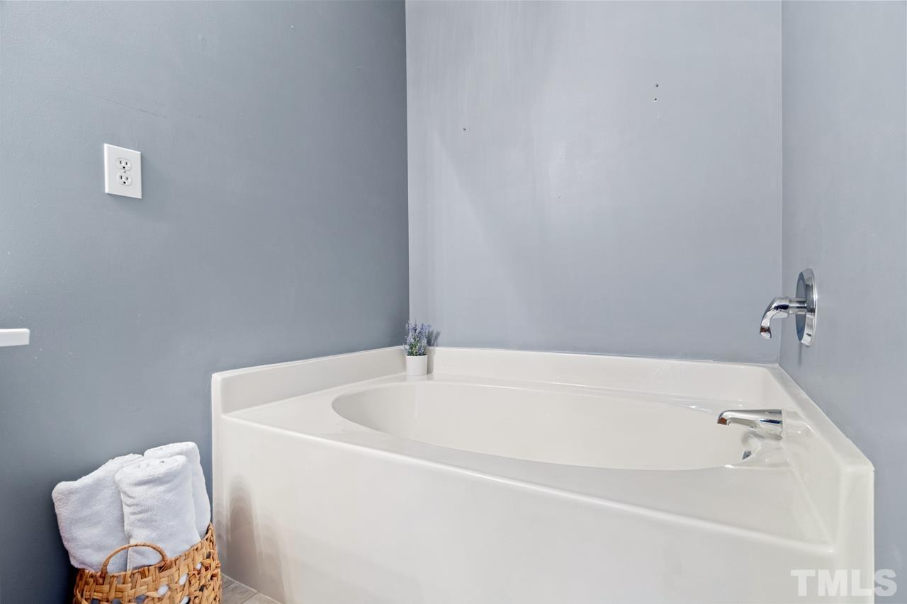 32 Brafferton Court Durham, NC 27713 - Photo 19 of 32 a white bath tub sitting in a bathroom