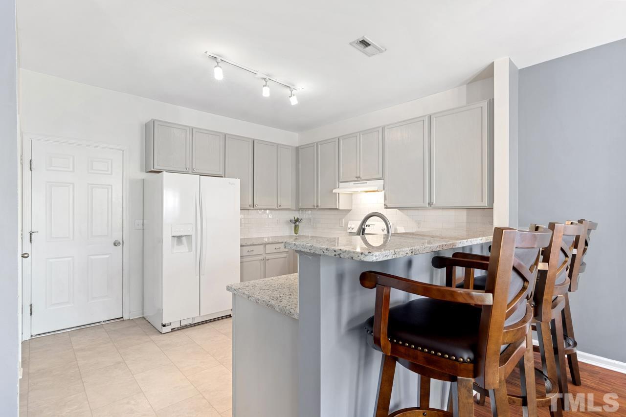 32 Brafferton Court Durham, NC 27713 - Photo 7 of 32 a kitchen with stainless steel appliances granite countertop a refrigerator and a stove top oven