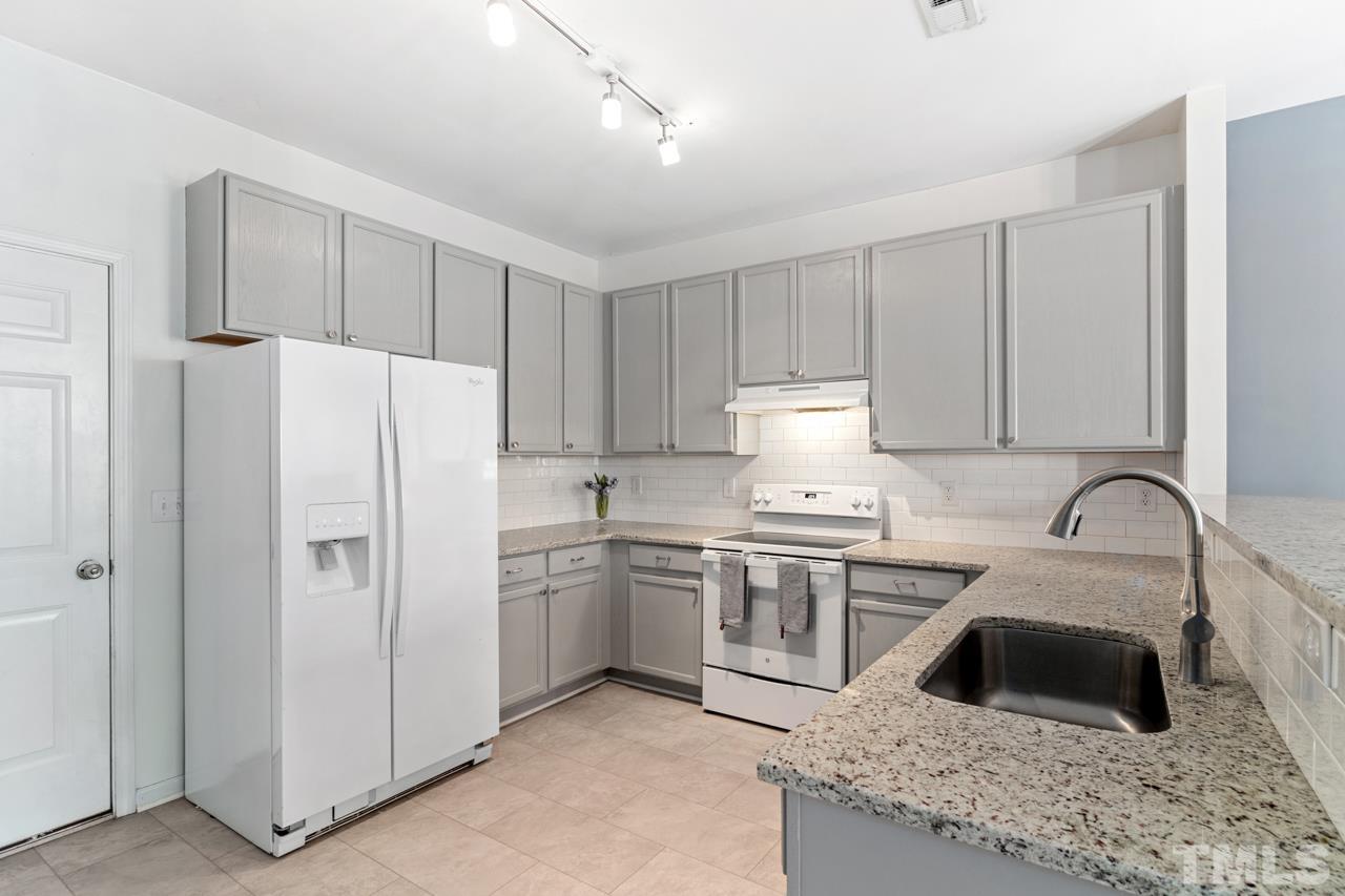 32 Brafferton Court Durham, NC 27713 - Photo 8 of 32 a kitchen with stainless steel appliances granite countertop a sink stove and refrigerator
