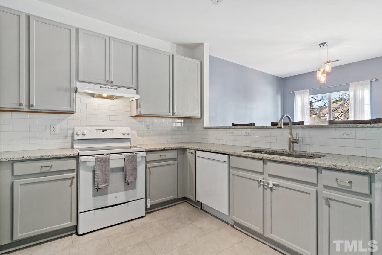 32 Brafferton Court Durham, NC 27713 - Photo 10 of 32 a kitchen with granite countertop white cabinets and white appliances