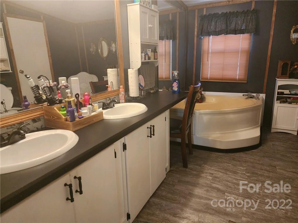 20 Beulah Road Ruby, SC 29741 - Photo 15 of 24 a bathroom with a double vanity sink a mirror and a bathtub