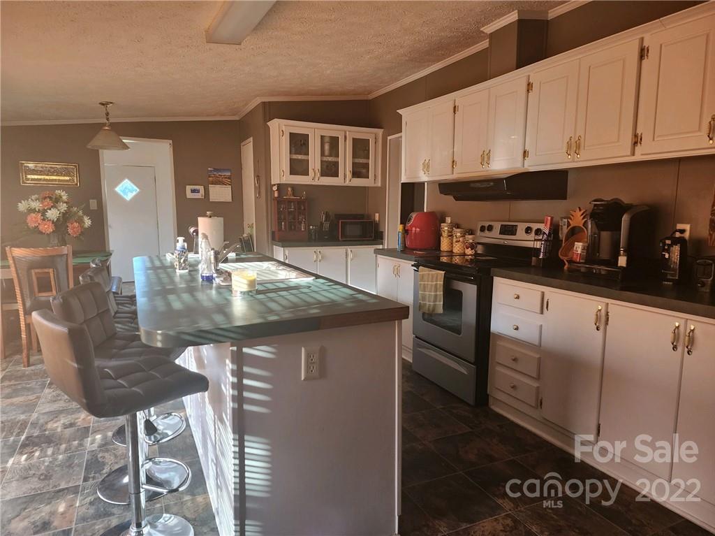 20 Beulah Road Ruby, SC 29741 - Photo 9 of 24 a kitchen with stainless steel appliances granite countertop a stove a sink a refrigerator and cabinets