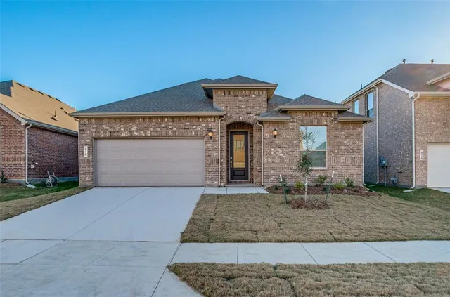a front view of a house with yard