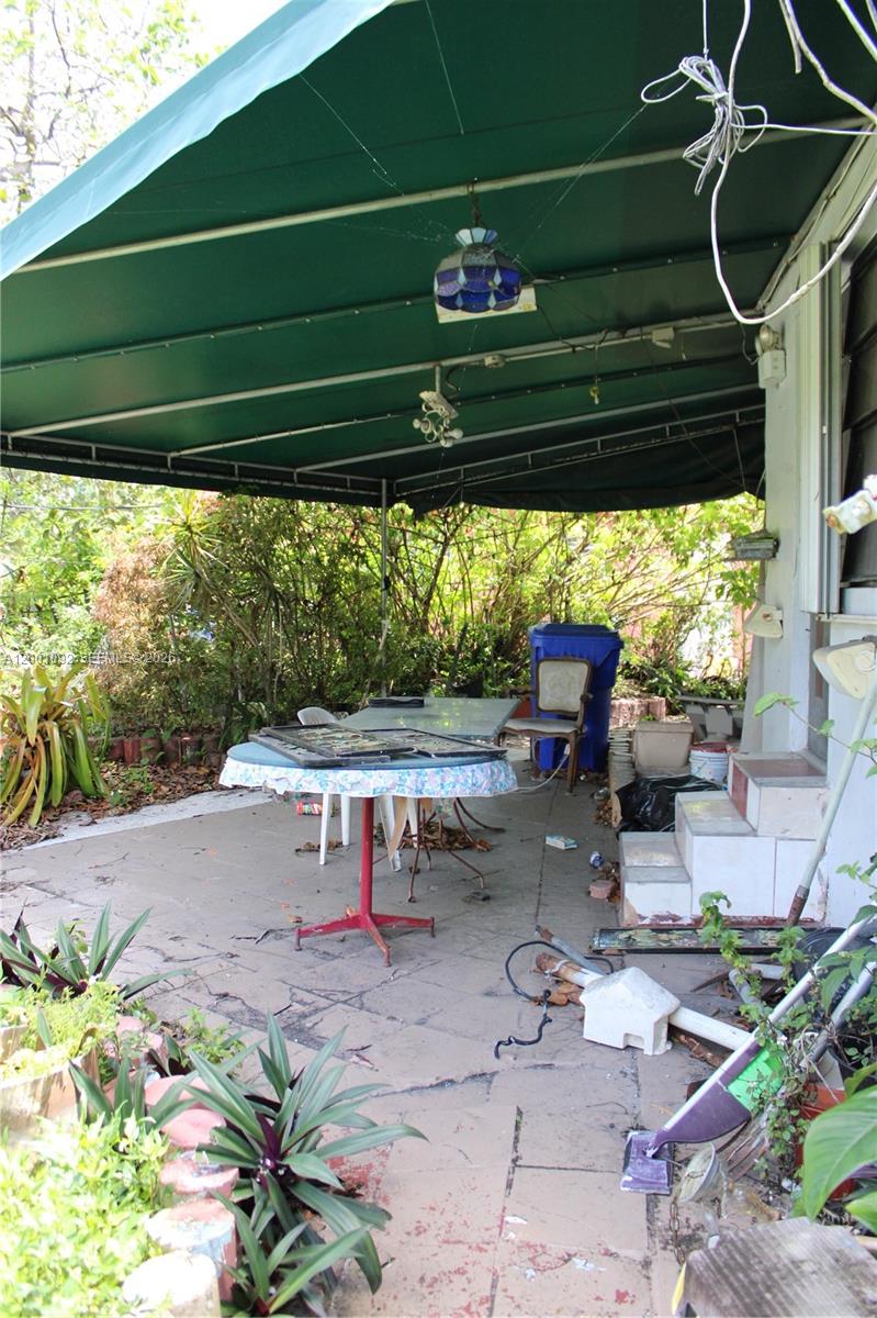 111 Northwest 52nd Street Miami, FL 33127 - Photo 12 of 14 a view of a porch with furniture and yard
