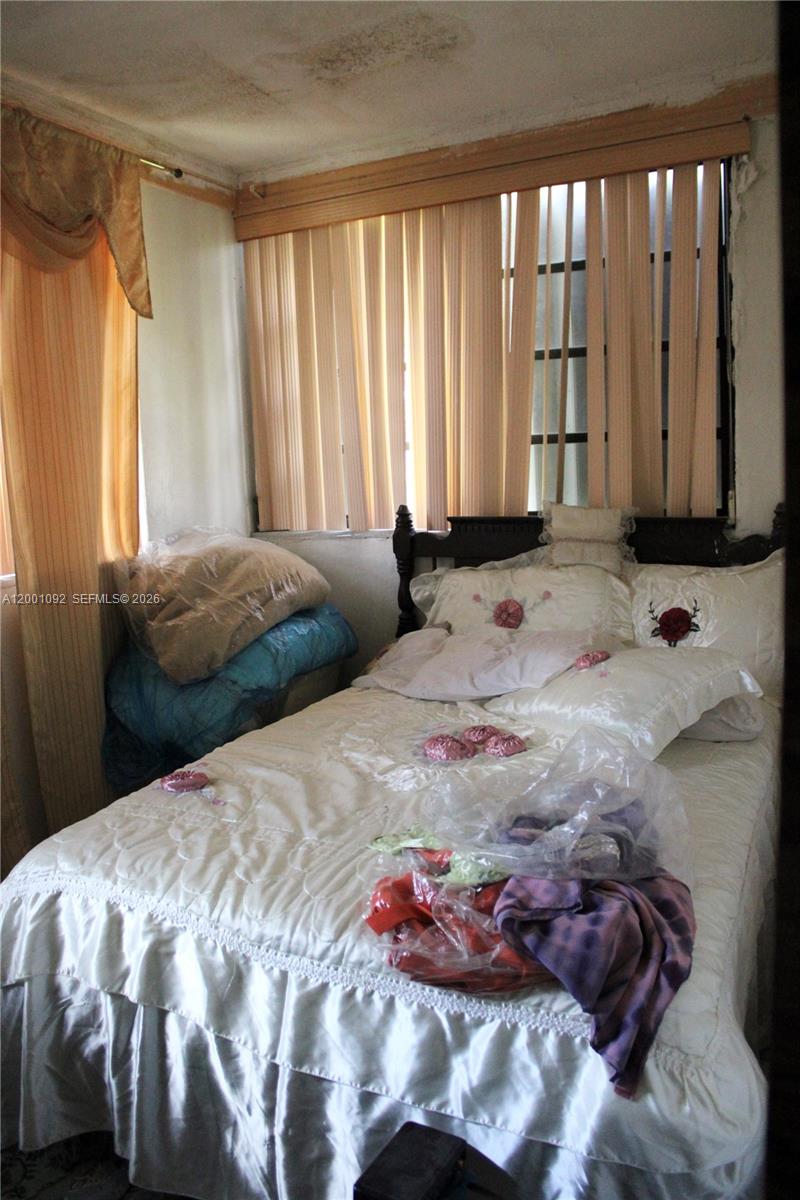 111 Northwest 52nd Street Miami, FL 33127 - Photo 2 of 14 a bedroom with a bed and a window