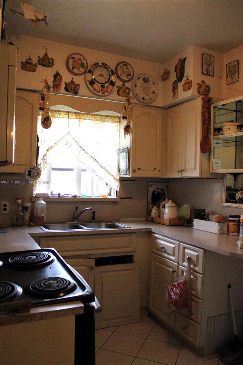 111 Northwest 52nd Street Miami, FL 33127 - Photo 4 of 14 a kitchen with granite countertop a stove and a sink
