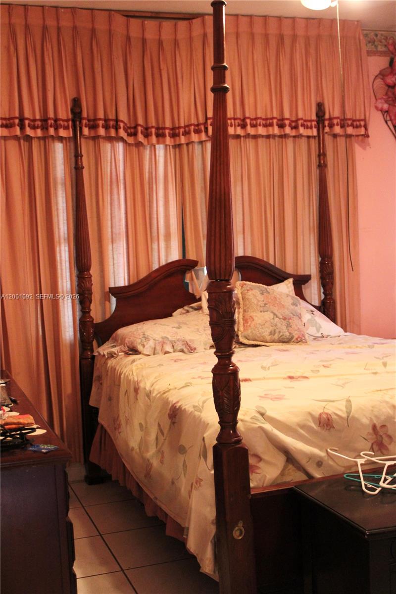 111 Northwest 52nd Street Miami, FL 33127 - Photo 6 of 14 a bedroom with a bed and a window