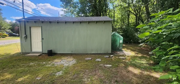 a backyard of a house with a tree