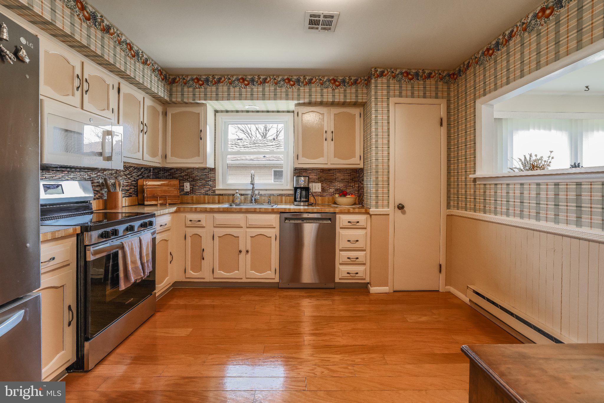 27 Magnolia Road Manahawkin, NJ 08050 - Photo 11 of 26 a kitchen with stainless steel appliances granite countertop a stove a sink and a refrigerator