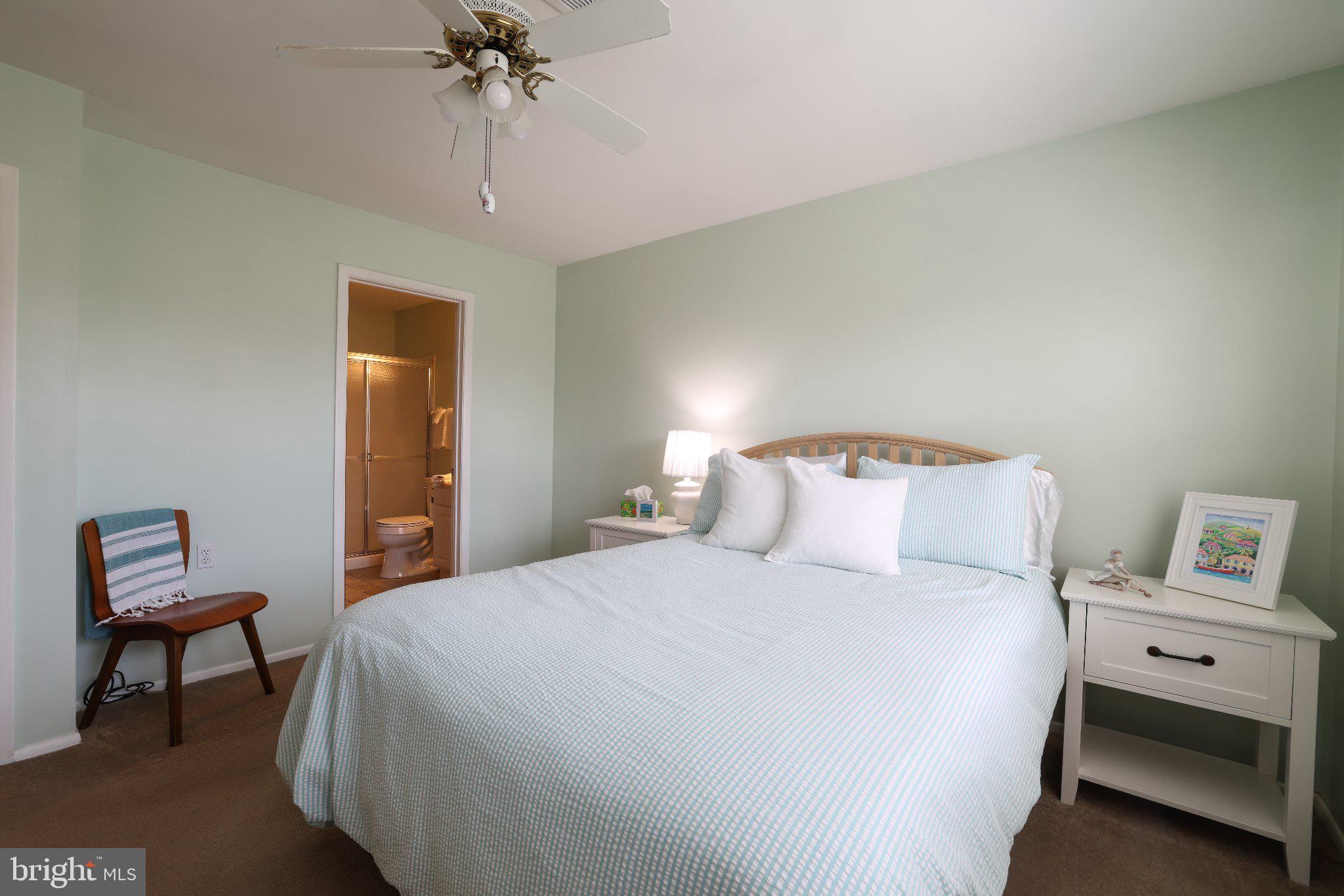 27 Magnolia Road Manahawkin, NJ 08050 - Photo 14 of 26 a bedroom with a bed and a chandelier