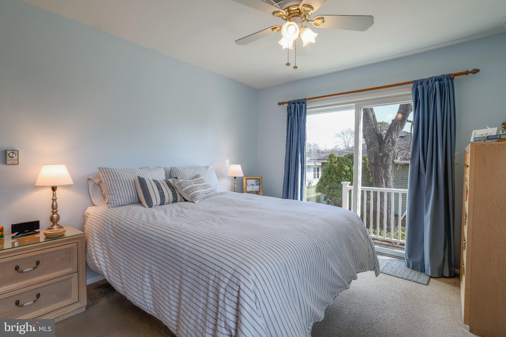 27 Magnolia Road Manahawkin, NJ 08050 - Photo 17 of 26 a bedroom with a large bed and a chandelier