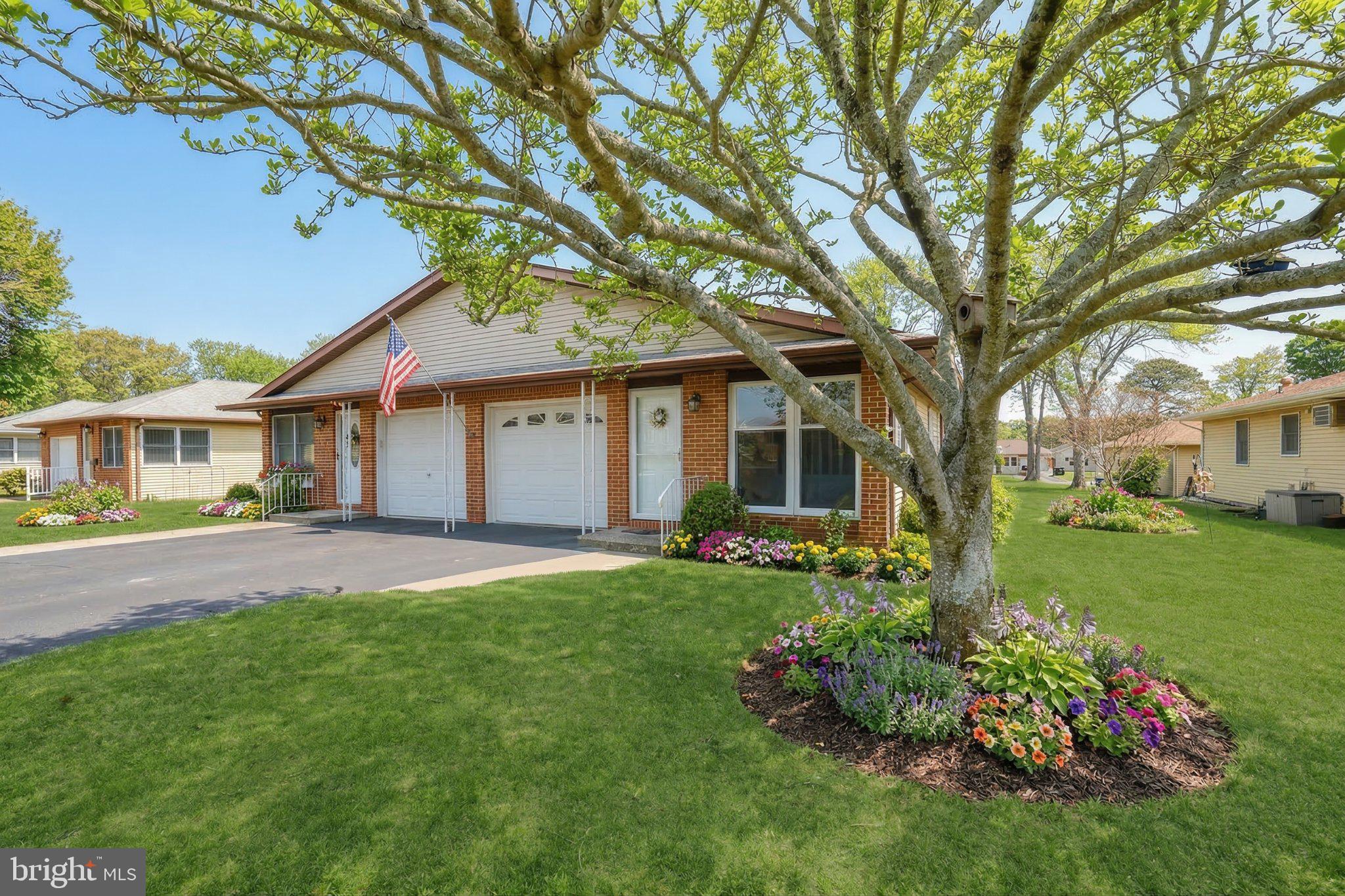 27 Magnolia Road Manahawkin, NJ 08050 - Photo 3 of 26 front view of a house with a garden