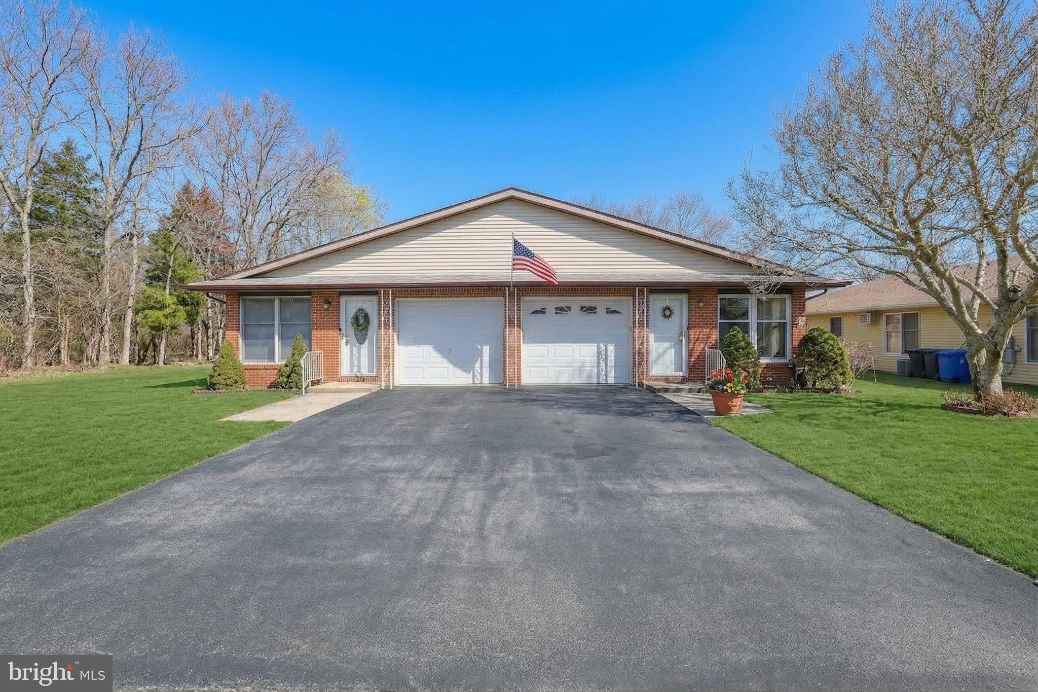 27 Magnolia Road Manahawkin, NJ 08050 - Photo 4 of 26 a front view of a house with a yard and garage