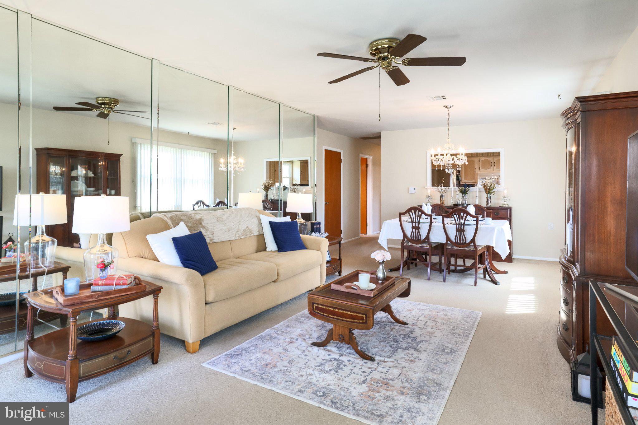 27 Magnolia Road Manahawkin, NJ 08050 - Photo 6 of 26 a living room with furniture a rug and a chandelier