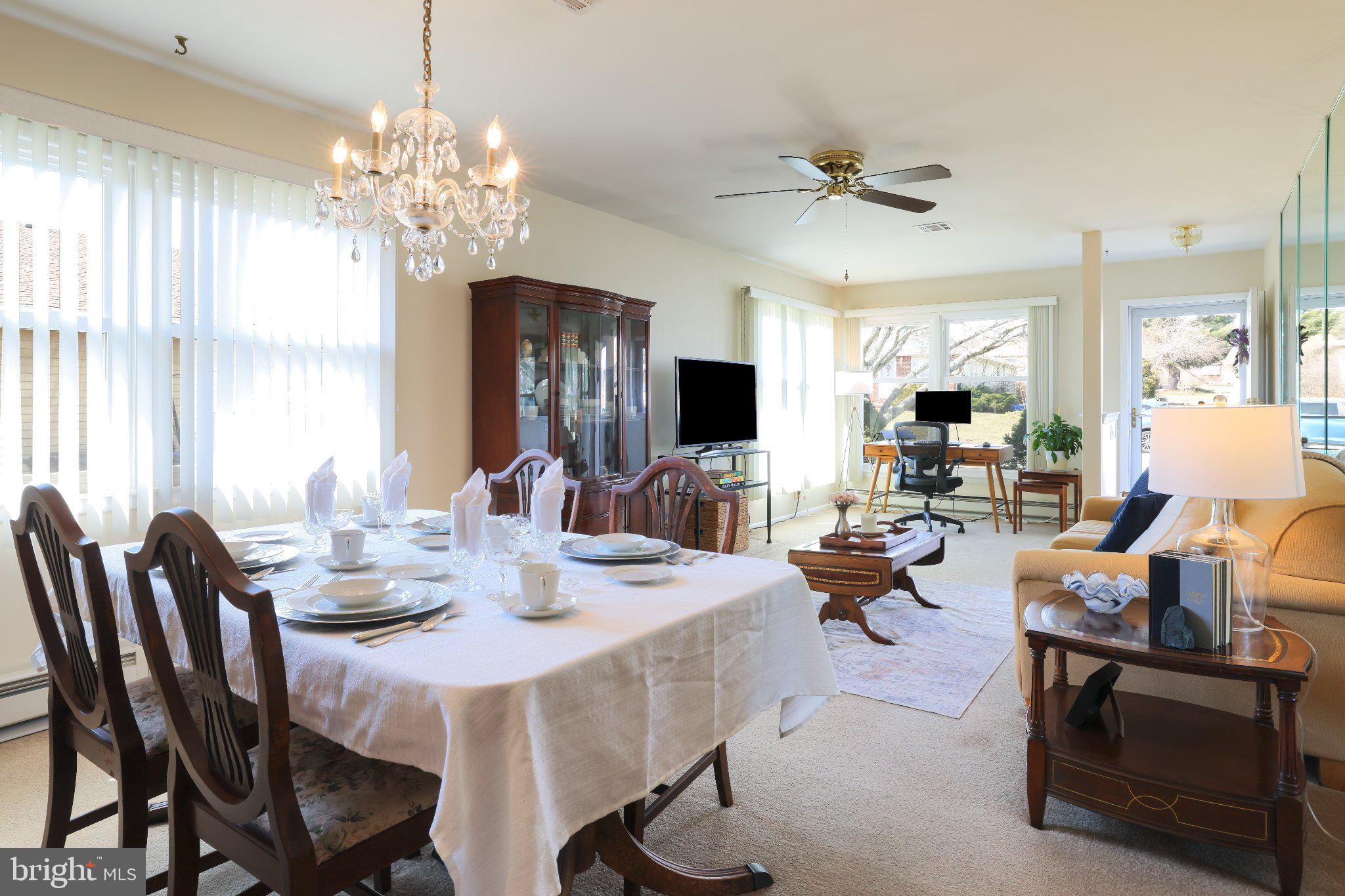 27 Magnolia Road Manahawkin, NJ 08050 - Photo 10 of 26 a view of a dining room with furniture a chandelier and large windows