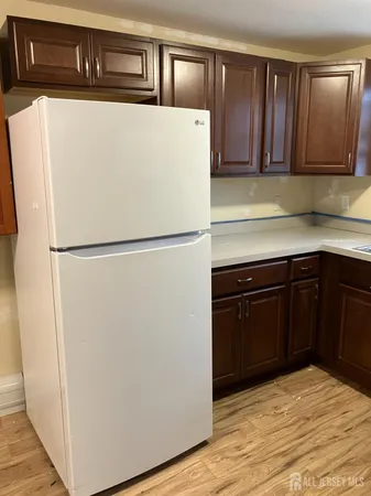 a white refrigerator freezer sitting in a kitchen