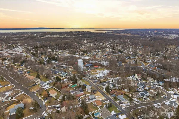an aerial view of residential houses with city view