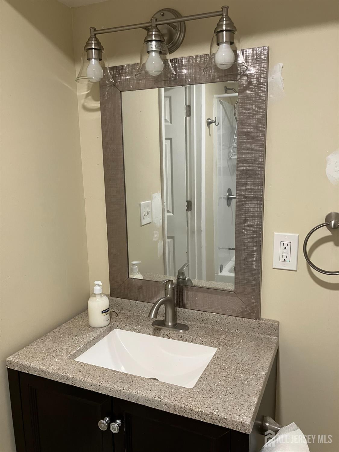 49 B Middlesex Road Old Bridge, NJ 07747 - Photo 5 of 14 a bathroom with a granite countertop sink a mirror and shower