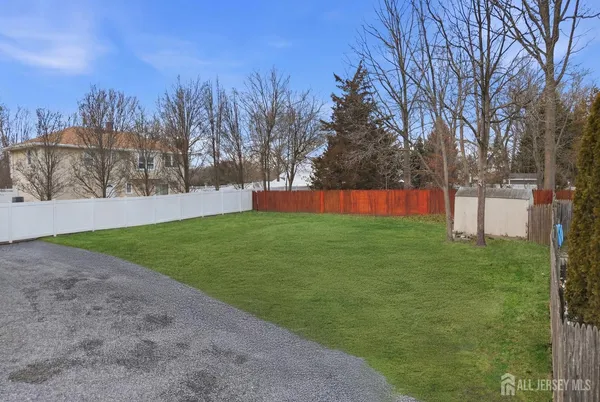 a view of yard with tree in the background