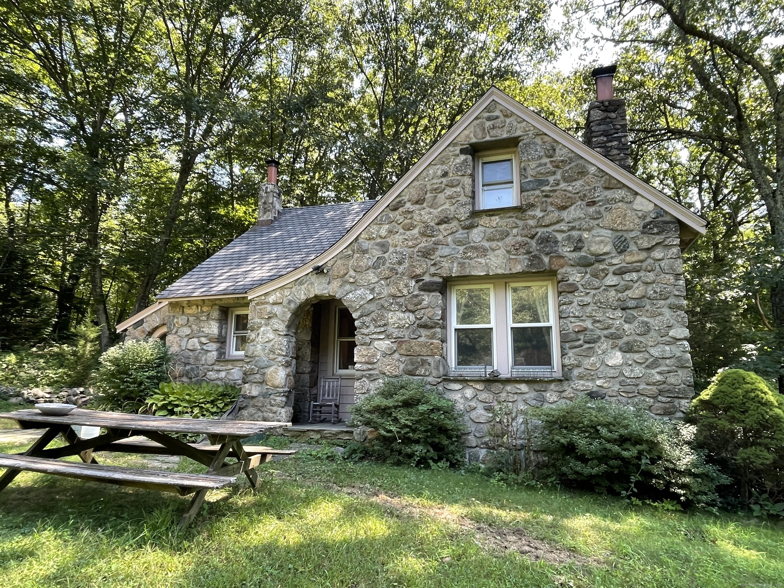 a front view of a house with a garden