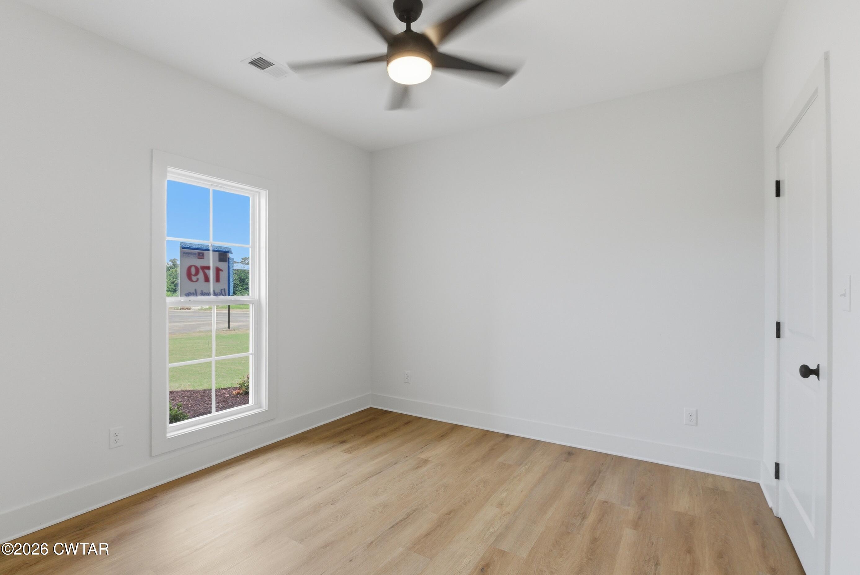 179 Daybreak Loop Medina, TN 38355 - Photo 25 of 32 wooden floor in an empty room with a window