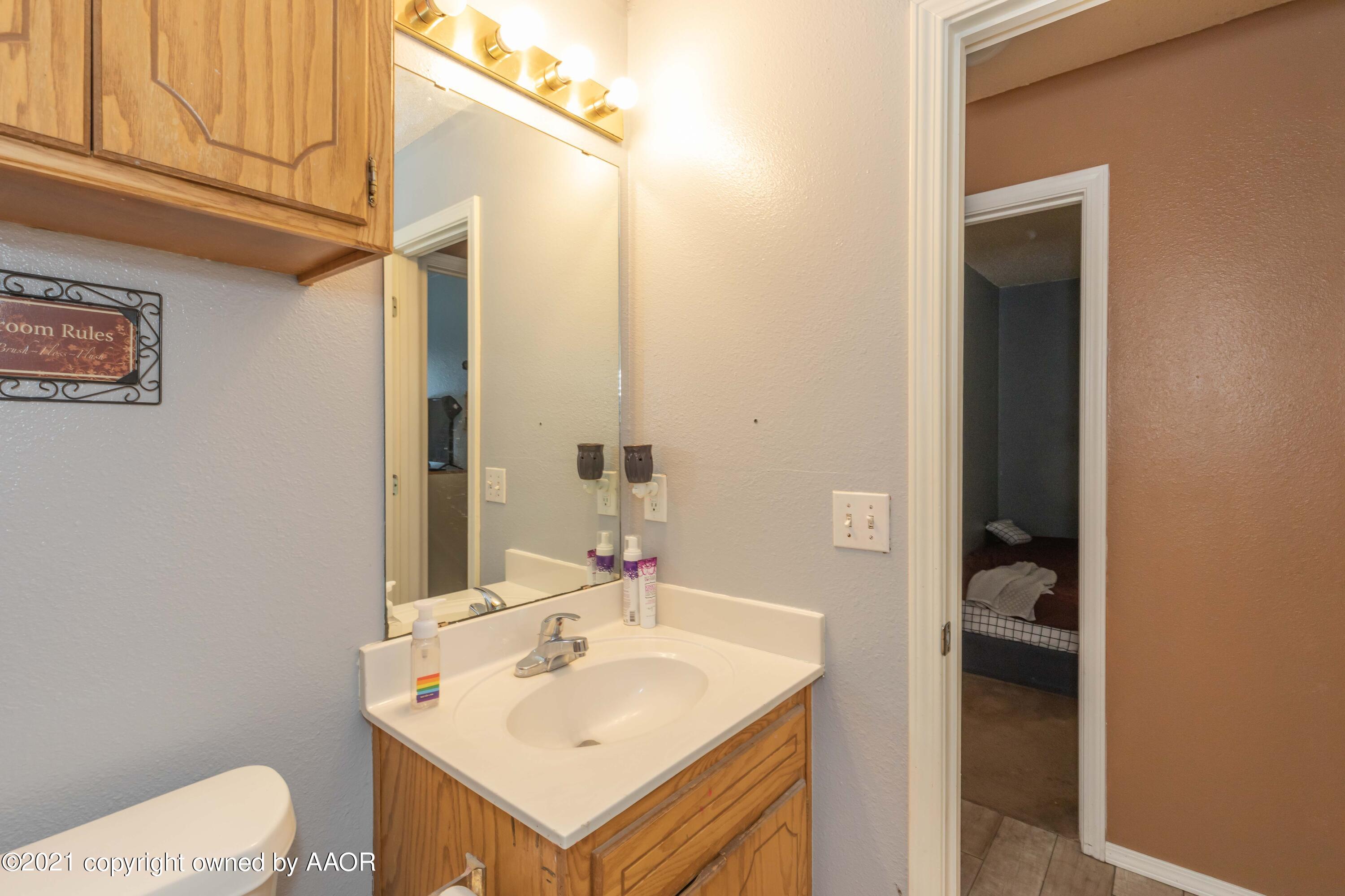 1025 Ketler Street Amarillo, TX 79104 - Photo 16 of 31 a bathroom with a sink toilet and vanity
